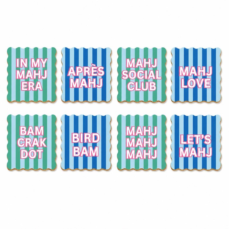 May include: A set of eight square coasters with scalloped edges, featuring vertical blue and green stripes. Each coaster displays pink text: IN MY MAHJ ERA, APR&Egrave;S MAHJ, MAHJ SOCIAL CLUB, MAHJ LOVE, BAM CRAK DOT, BIRD BAM, MAHJ MAHJ MAHJ, and LET'S MAHJ.