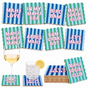 May include: A set of square coasters with scalloped edges, featuring vertical blue and green stripes and pink text. Phrases include MAHJ LOVE, IN MY MAHJ ERA, BIRD BAM, MAHJ SOCIAL CLUB, MAHJ MAHJ MAHJ, APR&Egrave;S MAHJ, BAM CRAK DOT, and LET'S MAHJ.