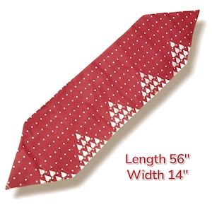 May include: A red table runner with white polka dots and heart-shaped designs along the edges. The runner is 56 inches long and 14 inches wide. The text on the image reads "Length 56" Width 14".