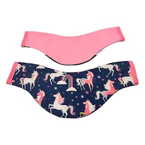 May include: Two fabric headbands. One is solid pink, the other is navy blue with a pattern of white and pink unicorns, rainbows, and stars. Both headbands have pink trim.