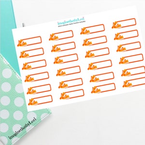 May include: A sheet of orange and white stickers with a pair of orange sneakers on each sticker. The stickers are rectangular and have a blank space for writing. The text "imaginethatbyLori" appears at the top and bottom of the sheet.