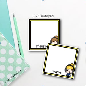 May include: Two 3 x 3 inch notepads with black and yellow borders. One notepad has the name "meliss" and a cartoon image. The other notepad has the name "Carin" and a cartoon image. A green pen and a mint green polka dot notebook are in the background.
