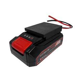 May include: Black and red power tool battery with a black top and red accents. The battery has a red button and a series of indicator lights. The text "LION 2.5Ah 18V" and "Power X-Change" are visible.