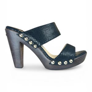 May include: A set of three ceramic mugs with a speckled, matte finish. The mugs are in shades of cream, light gray, and dark gray. Each mug has a simple, minimalist design and a rounded handle.