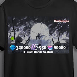 May include: Black t-shirt featuring a graphic from Darkcacao. The graphic includes a moon, figures, and text. The text includes the words "Darkcacao" and "2+ High Rarity Cookies" along with numbers and icons. The shirt also has Apple and Android icons.