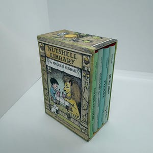 May include: A boxed set of miniature books titled "Nutshell Library" by Maurice Sendak. The box features a colorful illustration of a boy and a lion. The spines of the books are visible, with titles like "Chicken Soup with Rice" and "Pierre."