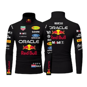 May include: Black long-sleeve turtleneck shirt featuring multiple logos, including "Red Bull," "Oracle," and "Ford Racing." The shirt has a design with a red, yellow, and white color scheme. The Dutch flag is also visible on the shirt.