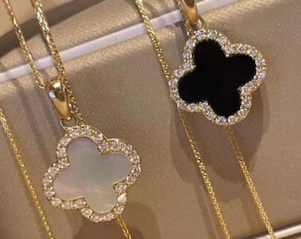 Four-leaf clover pendant necklaces featuring sparkling crystal halos