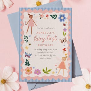May include: A light blue envelope with a pink and blue invitation. The invitation reads "Join us to celebrate ANABELLE'S fairy first BIRTHDAY" with floral and fairy illustrations. The date and time are included. The invitation is surrounded by flowers.