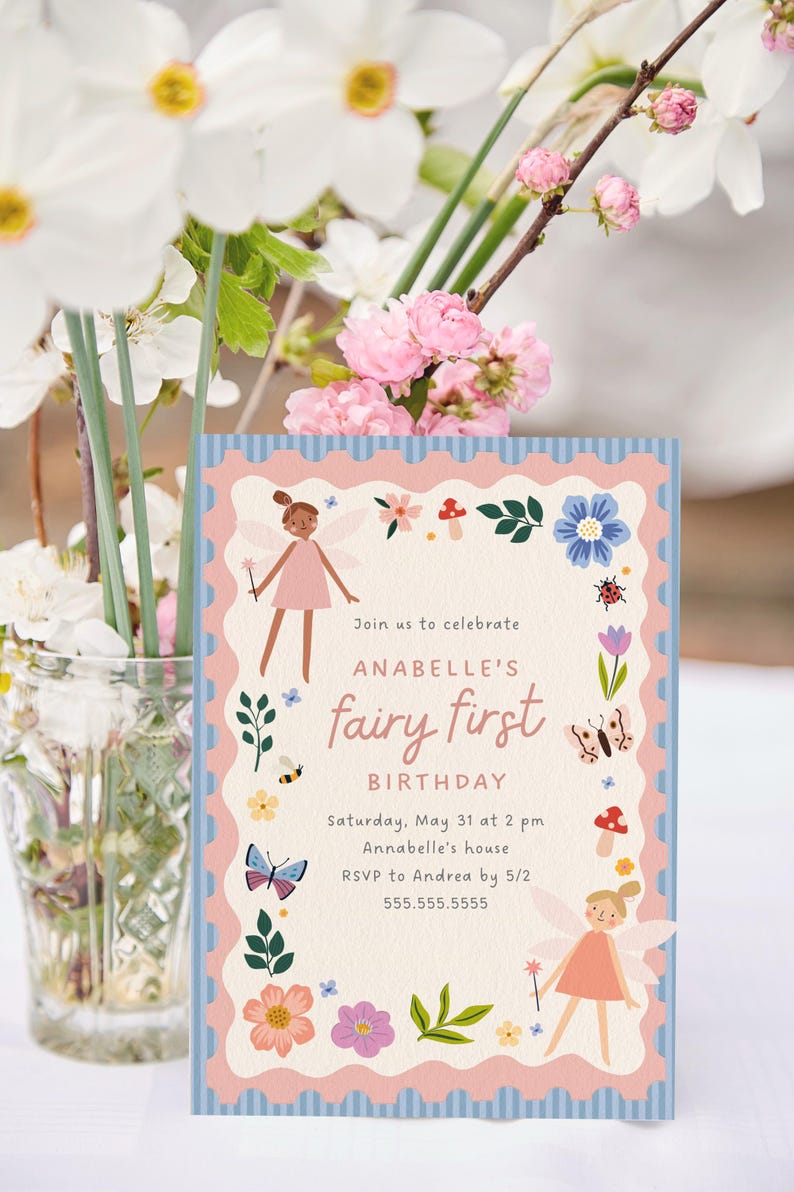 May include: A birthday invitation with a fairy theme. The invitation features a pink and blue scalloped border with illustrations of fairies, flowers, and insects. The text reads "Join us to celebrate ANABELLE'S fairy first BIRTHDAY".