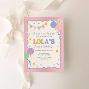 May include: A pastel pink and white birthday invitation with the text "It's fun to be one!" and "LOLA'S first birthday." The invitation includes balloons, stars, and a banner. The invitation is for Sunday, May 31 at 2 PM.
