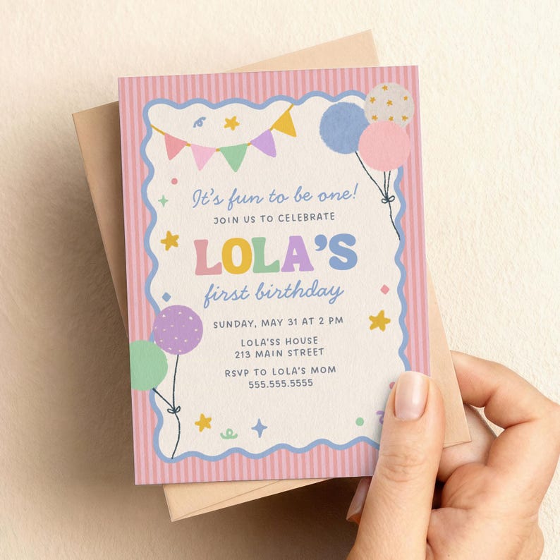 May include: A pastel pink and blue birthday invitation with the text "It's fun to be one!" and "LOLA'S first birthday." The invitation features balloons, stars, and a banner design. The invitation is held in a person's hand.