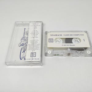 May include: A clear plastic cassette tape case with a tracklist insert and a matching cassette tape. The tape label reads NINAJIRACHI I LOVE MY COMPUTER with the NLV Records logo and 2025 date. The insert features a blue line art illustration.