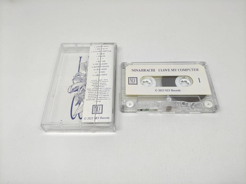 May include: A clear plastic cassette tape case with a tracklist insert and a matching cassette tape. The tape label reads NINAJIRACHI I LOVE MY COMPUTER with the NLV Records logo and 2025 date. The insert features a blue line art illustration.