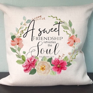 May include: White throw pillow with a floral wreath design and the text "A sweet friendship refreshes the soul, Proverbs 27:9".