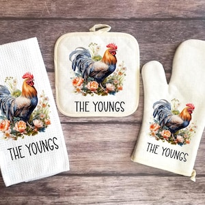 May include: A set of three kitchen towels featuring a rooster with floral accents. The towels are white with black text that reads "The Youngs".
