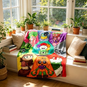 May include: A colorful blanket featuring cartoon characters in a hexagonal pattern. The blanket has a variety of colors, including orange, green, purple, and red. The blanket is draped over a window seat with plants and pillows.