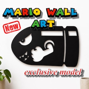 Könnte beinhalten: Ein schwarzes Wandkunstobjekt in Form einer Bullet Bill-Figur mit grimmigem Gesicht, spitzen Zähnen und einem angewinkelten Arm. Der Text MARIO WALL ART steht darüber in bunten Buchstaben, mit einem roten New-Etikett und dem Text exclusive model.