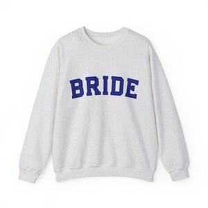 Bride Crewneck Bridal Sweatshirt Engaged gift for her custom mrs shirt announce engagement personalized wifey get married custom engaged shirt bride getting ready outfit future mrs engaged just engaged gift just married shirt bride hoodie mrs hoodie wifey sweatshirt bride mrs sweatshirt. bride clothes, wedding newly engaged gift. This is a custom bride crewneck bridal sweatshirt. It's a gildan 18000 crewneck sweatshirt.