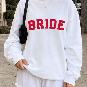 Bride Crewneck Bridal Sweatshirt Engaged gift for her custom mrs shirt announce engagement personalized wifey get married custom engaged shirt bride getting ready outfit future mrs engaged just engaged gift just married shirt bride hoodie mrs hoodie wifey sweatshirt bride mrs sweatshirt. bride clothes, wedding newly engaged gift. This is a custom bride crewneck bridal sweatshirt. It's a gildan 18000 crewneck sweatshirt.