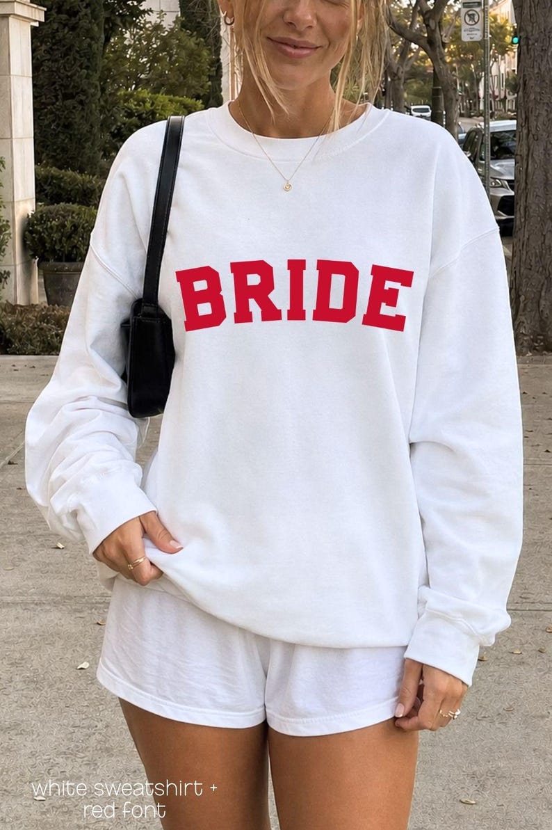 Bride Crewneck Bridal Sweatshirt Engaged gift for her custom mrs shirt announce engagement personalized wifey get married custom engaged shirt bride getting ready outfit future mrs engaged just engaged gift just married shirt bride hoodie mrs hoodie wifey sweatshirt bride mrs sweatshirt. bride clothes, wedding newly engaged gift. This is a custom bride crewneck bridal sweatshirt. It's a gildan 18000 crewneck sweatshirt.