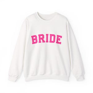 Bride Crewneck Bridal Sweatshirt Engaged gift for her custom mrs shirt announce engagement personalized wifey get married custom engaged shirt bride getting ready outfit future mrs engaged just engaged gift just married shirt bride hoodie mrs hoodie wifey sweatshirt bride mrs sweatshirt. bride clothes, wedding newly engaged gift. This is a custom bride crewneck bridal sweatshirt. It's a gildan 18000 crewneck sweatshirt.