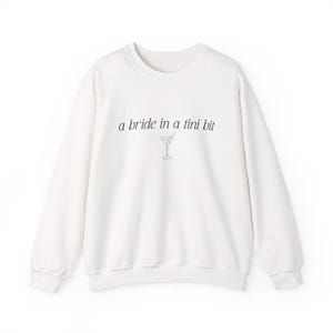 Bride in a Tini Bit Bride Shirt Tini Bit Engaged Bachelorette Party Custom Bachelorette Shirt for Bride to Be, Bride Sweatshirt Future Mrs Shirt, Mrs Personalized Bride Shirt | Bride Clothes Future Mrs Engaged Custom Mrs Shirt Custom Wife Shirt. Bridal Sweatshirt Bachelorette Shirts. Custom Bachelorette Shirt Bachelorette Party Shirts. Custom Bridesmaid Shirts This is a personalized getting ready outfit for wedding day. Perfect for a wedding newly engaged gift. It is a comfort colors 1717 shirt.