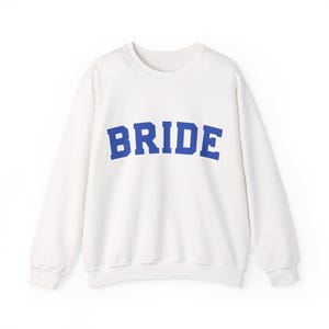 Bride Crewneck Bridal Sweatshirt Engaged gift for her custom mrs shirt announce engagement personalized wifey get married custom engaged shirt bride getting ready outfit future mrs engaged just engaged gift just married shirt bride hoodie mrs hoodie wifey sweatshirt bride mrs sweatshirt. bride clothes, wedding newly engaged gift. This is a custom bride crewneck bridal sweatshirt. It's a gildan 18000 crewneck sweatshirt.