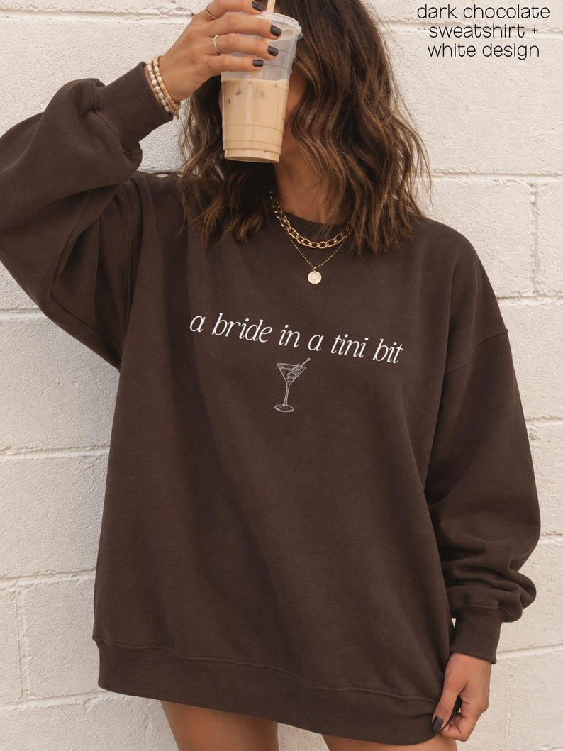 Bride in a Tini Bit Bride Shirt Tini Bit Engaged Bachelorette Party Custom Bachelorette Shirt for Bride to Be, Bride Sweatshirt Future Mrs Shirt, Mrs Personalized Bride Shirt | Bride Clothes Future Mrs Engaged Custom Mrs Shirt Custom Wife Shirt. Bridal Sweatshirt Bachelorette Shirts. Custom Bachelorette Shirt Bachelorette Party Shirts. Custom Bridesmaid Shirts This is a personalized getting ready outfit for wedding day. Perfect for a wedding newly engaged gift. It is a comfort colors 1717 shirt.