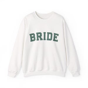 Bride Crewneck Bridal Sweatshirt Engaged gift for her custom mrs shirt announce engagement personalized wifey get married custom engaged shirt bride getting ready outfit future mrs engaged just engaged gift just married shirt bride hoodie mrs hoodie wifey sweatshirt bride mrs sweatshirt. bride clothes, wedding newly engaged gift. This is a custom bride crewneck bridal sweatshirt. It's a gildan 18000 crewneck sweatshirt.