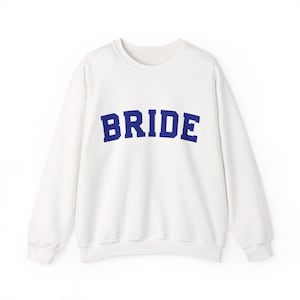 Bride Crewneck Bridal Sweatshirt Engaged gift for her custom mrs shirt announce engagement personalized wifey get married custom engaged shirt bride getting ready outfit future mrs engaged just engaged gift just married shirt bride hoodie mrs hoodie wifey sweatshirt bride mrs sweatshirt. bride clothes, wedding newly engaged gift. This is a custom bride crewneck bridal sweatshirt. It's a gildan 18000 crewneck sweatshirt.
