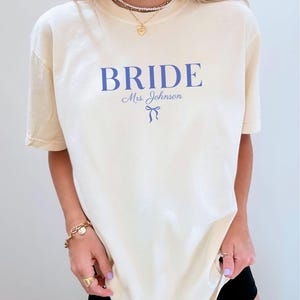 Bride Shirt, Bridesmaid Shirts Bridesmaids Proposal Maid of Honor shirt Matron of honor shirt, Future Mrs Engaged Shirt, Mrs Personalized Bride Shirt | Custom Engaged Shirt, Future Mrs Engaged, Custom Mrs Shirt, Custom Wife Shirt. Bachelorette Shirts. Custom Bachelorette Shirt. Bachelorette Party Shirts. Bride Shirt, Custom Bride, Custom Bridesmaid Shirts, Bridal party. A comfort colors 1717 shirt for a wedding day, perfect for wedding getting ready outfits.