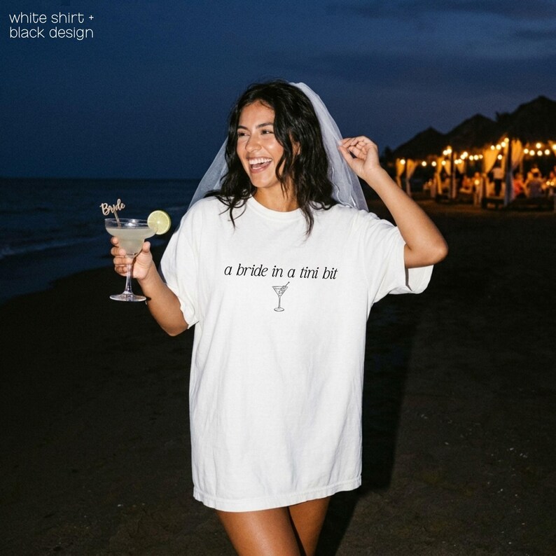 Bride in a Tini Bit Bride Shirt Tini Bit Engaged Bachelorette Party Custom Bachelorette Shirt for Bride to Be, Bride Sweatshirt Future Mrs Shirt, Mrs Personalized Bride Shirt | Bride Clothes Future Mrs Engaged Custom Mrs Shirt Custom Wife Shirt. Bridal Sweatshirt Bachelorette Shirts. Custom Bachelorette Shirt Bachelorette Party Shirts. Custom Bridesmaid Shirts This is a personalized getting ready outfit for wedding day. Perfect for a wedding newly engaged gift. It is a comfort colors 1717 shirt.