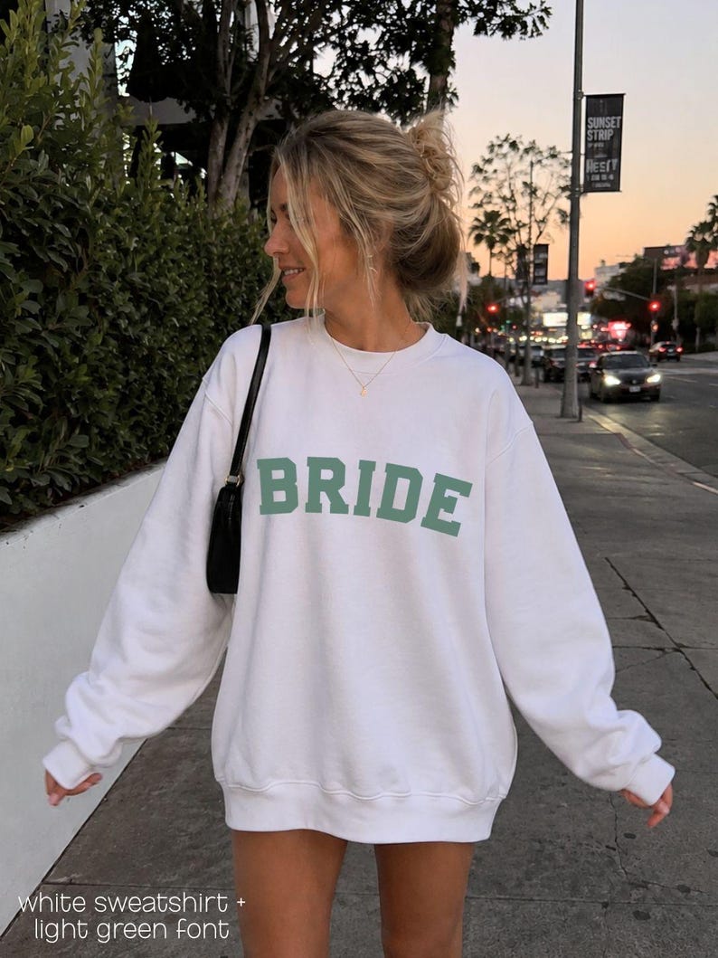 Bride Crewneck Bridal Sweatshirt Engaged gift for her custom mrs shirt announce engagement personalized wifey get married custom engaged shirt bride getting ready outfit future mrs engaged just engaged gift just married shirt bride hoodie mrs hoodie wifey sweatshirt bride mrs sweatshirt. bride clothes, wedding newly engaged gift. This is a custom bride crewneck bridal sweatshirt. It's a gildan 18000 crewneck sweatshirt.