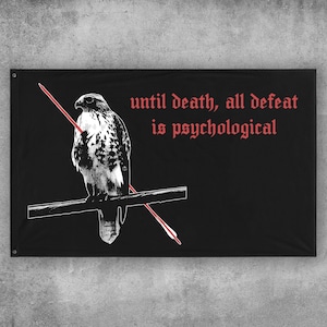 May include: A rectangular black wall banner featuring a white graphic illustration of a hawk perched on a branch. A red arrow pierces the hawk diagonally. The text "until death, all defeat is psychological" is printed in red in a gothic font.