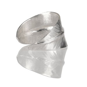 May include: A silver ring with a leaf design. The ring is made of metal and has a textured surface.