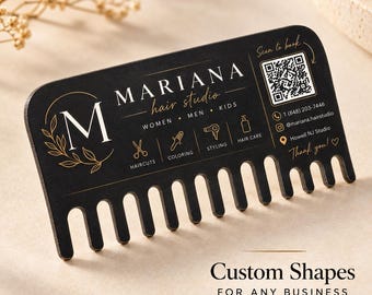 May include: A black business card shaped like a wide-tooth comb with gold text and graphics. It features the text Mariana Hair Studio, a QR code, phone number, social media handle, and location. Icons represent haircuts, coloring, styling, and hair care.