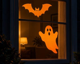 May include: Two orange window decals applied to a glass pane. The top decal is a bat with pointed ears and outstretched wings. The bottom decal is a ghost with two round eyes and an oval-shaped mouth, both featuring a solid, vibrant orange color.