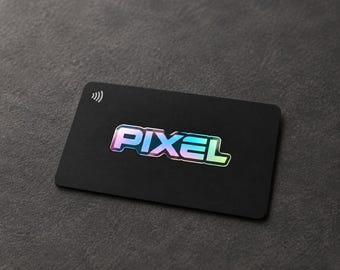 May include: A rectangular black card featuring the word PIXEL in a holographic, iridescent font centered on the surface. In the top left corner, there is a white contactless payment symbol consisting of four curved lines of increasing size.