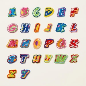 May include: A collection of colorful, embroidered alphabet letters. Each letter features a unique design with vibrant colors like blue, pink, green, and yellow. The letters are in a playful, bubble-style font, perfect for crafting or personalization projects.