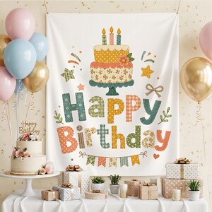 May include: A white fabric birthday backdrop featuring a two-tier cake illustration with three lit candles, surrounded by stars and the text Happy Birthday in multicolored patterned letters, accented by a small bunting banner at the bottom.