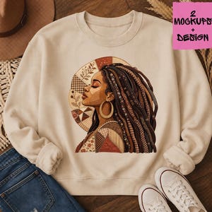 May include: Cream-colored sweatshirt featuring a side profile of a woman with long, patterned braids and large gold hoop earrings. The design includes a circular backdrop with patchwork and floral elements. The text "2 Mockups + Design" is in the upper right corner.