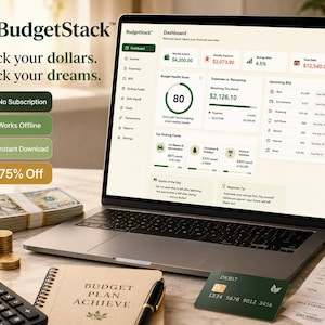 May include: A laptop displaying the BudgetStack financial dashboard software, featuring a Budget Health Score of 80, income, expense, and savings data. Beside the laptop are stacks of cash, a calculator, a debit card, and a budget planner notebook.