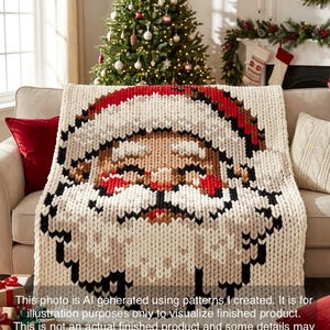 May include: A chunky knit throw blanket featuring a large, pixelated-style graphic of Santa Claus. The design uses cream, red, black, and tan yarn to depict a face with a hat, eyes, and a beard. The blanket has a thick, textured weave throughout.
