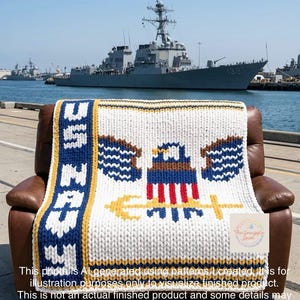May include: A chunky knit blanket featuring the US Navy emblem with a bald eagle, shield, and anchor in red, white, blue, and gold. The text US NAVY is vertically oriented on a blue stripe. The blanket is draped over a brown leather chair.