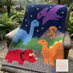 May include: A knitted blanket featuring a dinosaur design. The blanket has a dark blue background with a light blue dinosaur, a purple pterodactyl, and orange and red dinosaurs. The blanket is on a brown leather chair.