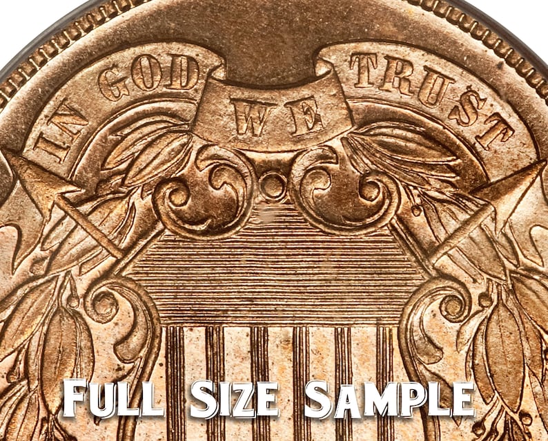 May include: Close-up of a gold-colored coin with the inscription "IN GOD WE TRUST" on the top half of the coin. The bottom half of the coin features a shield with vertical stripes and a design of two eagles with wings spread.