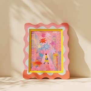May include: A framed art print with a whimsical illustration. The artwork features a person walking down a city street with colorful stars overhead and a goldfish. The frame is pink with a wavy edge and a yellow inner border.