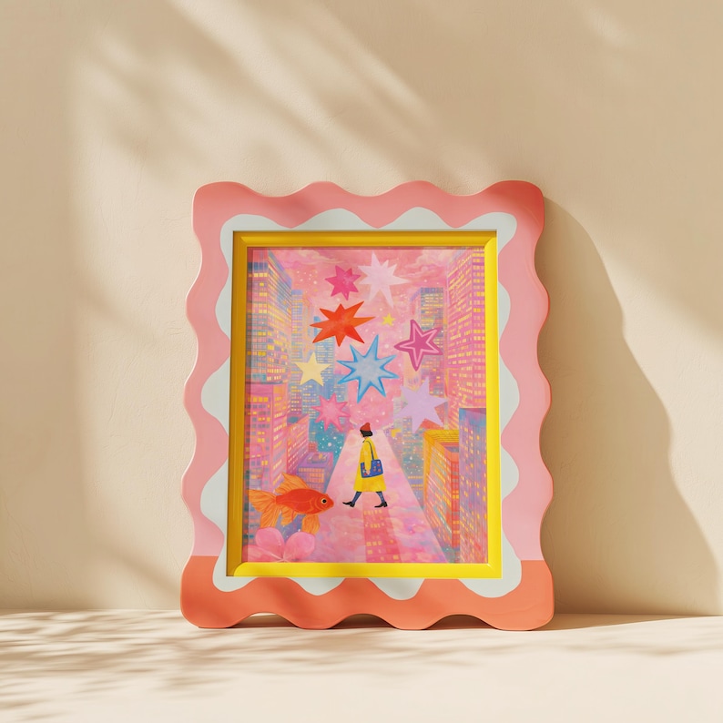 May include: A framed art print with a whimsical illustration. The artwork features a person walking down a city street with colorful stars overhead and a goldfish. The frame is pink with a wavy edge and a yellow inner border.