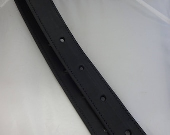 May include: A black leather belt with five holes and a pointed end. The belt is folded in half and the text "Best Leather" is visible on the end.